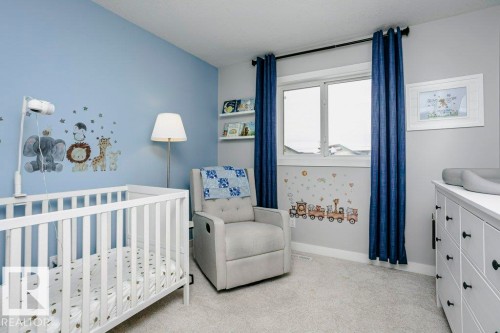 Bedroom with light colored carpet and a crib - 6710 Cardinal Road, Edmonton, AB - Indoor Photo Showing Bedroom