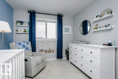 Bedroom with a nursery area and light carpet - 6710 Cardinal Road, Edmonton, AB - Indoor Photo Showing Bedroom