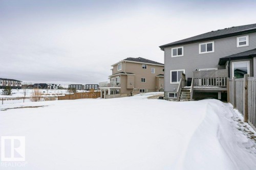 Yard layered in snow featuring a deck and a residential view - 6710 Cardinal Road, Edmonton, AB - Outdoor