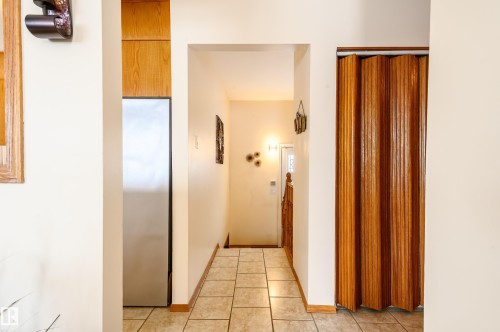 Hall featuring light tile patterned flooring and baseboards - 13420 113A St, Edmonton, AB - Indoor Photo Showing Other Room