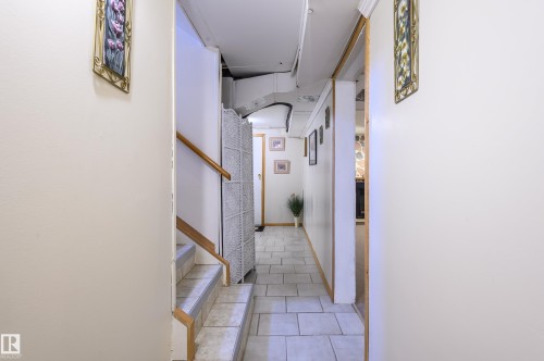 Hall featuring stairs and light tile patterned floors - 13420 113A St, Edmonton, AB - Indoor Photo Showing Other Room