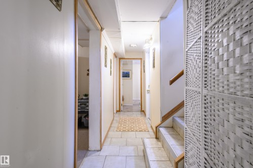 Hallway with light tile patterned floors and baseboards - 13420 113A St, Edmonton, AB - Indoor Photo Showing Other Room
