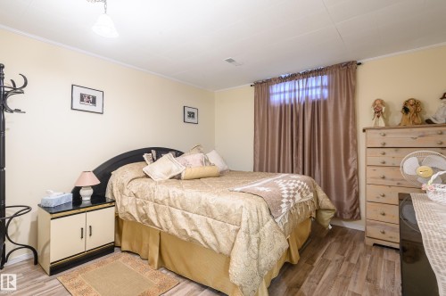 Bedroom with light wood-style flooring and crown molding - 13420 113A St, Edmonton, AB - Indoor Photo Showing Bedroom