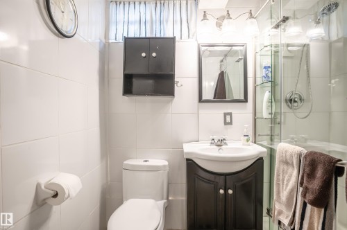 Full bathroom with vanity, a shower stall, and tile walls - 13420 113A St, Edmonton, AB - Indoor Photo Showing Bathroom