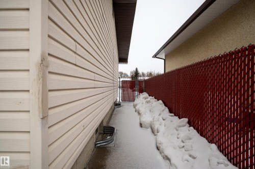 View of snowy exterior with a gate - 13420 113A St, Edmonton, AB - Outdoor With Exterior