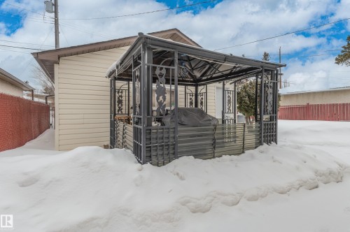 Snow covered house with a deck and a gazebo - 13420 113A St, Edmonton, AB - Outdoor With Exterior