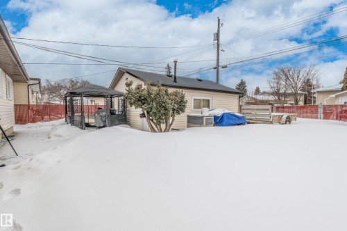 Snow covered back of property with a gazebo, a fenced backyard, and a deck - 13420 113A St, Edmonton, AB - Outdoor