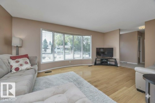 Living room featuring light wood-style floors - 4406 39 Ave, Leduc, AB - Indoor Photo Showing Living Room