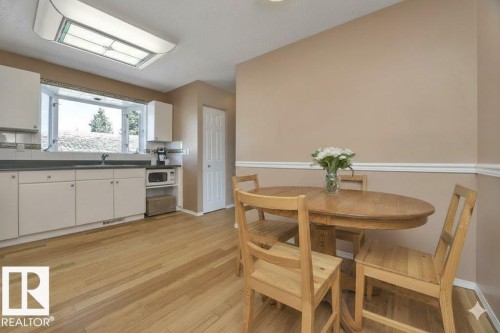 Dining room featuring light wood-type flooring and baseboards - 4406 39 Ave, Leduc, AB - Indoor Photo Showing Dining Room