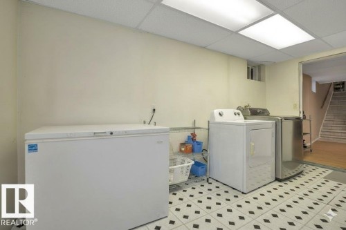 Laundry area featuring washer and clothes dryer, a paneled ceiling, and light flooring - 4406 39 Ave, Leduc, AB - Indoor Photo Showing Laundry Room