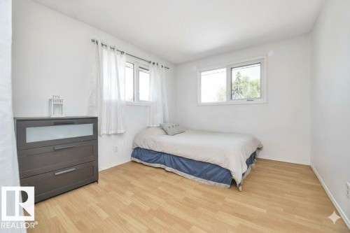 Bedroom with light wood-style flooring and baseboards - 4406 39 Ave, Leduc, AB - Indoor Photo Showing Bedroom
