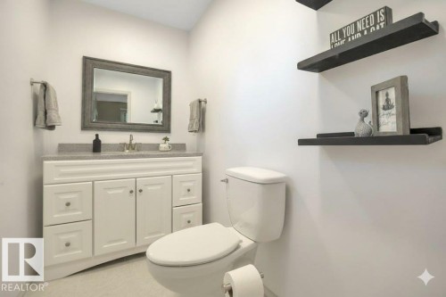 Half bath featuring toilet and vanity - 4406 39 Ave, Leduc, AB - Indoor Photo Showing Bathroom