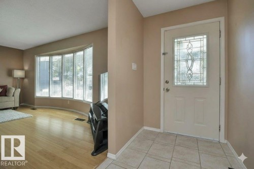 Doorway featuring baseboards and tile patterned floors - 4406 39 Ave, Leduc, AB - Indoor Photo Showing Other Room