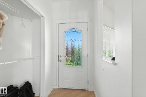 Entryway with wood finished floors and baseboards - 7836 7 Avenue, Edmonton, AB - Indoor