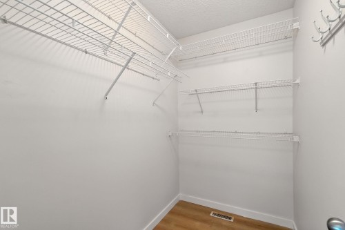 Walk in closet featuring light wood-style flooring - 7836 7 Avenue, Edmonton, AB - Indoor With Storage