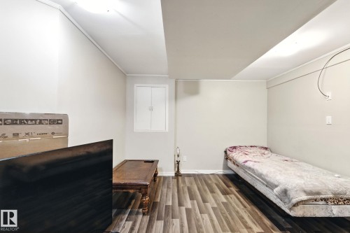 Bedroom featuring wood finished floors and crown molding - 7836 7 Avenue, Edmonton, AB - Indoor