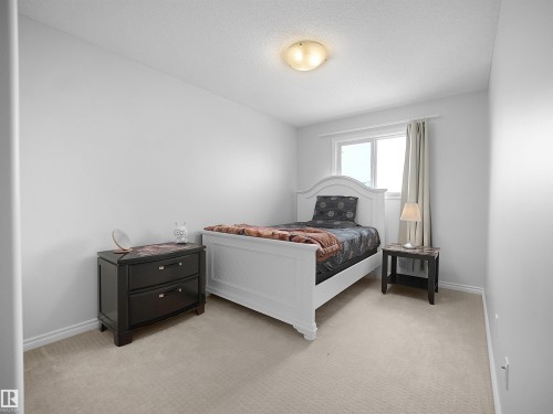 Bedroom featuring light colored carpet and a textured ceiling - 1716 64 Street, Edmonton, AB - Indoor Photo Showing Bedroom