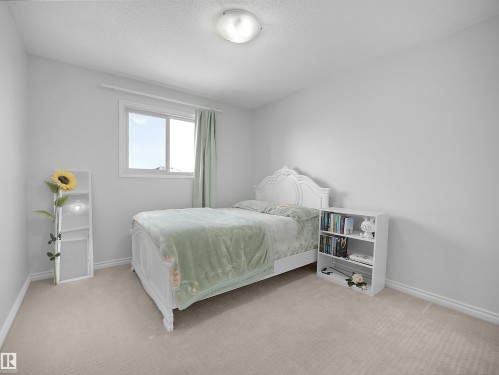 Bedroom with light carpet and a textured ceiling - 1716 64 Street, Edmonton, AB - Indoor Photo Showing Bedroom