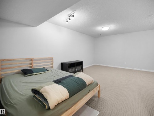 Finished basement featuring carpet and a textured ceiling - 1716 64 Street, Edmonton, AB - Indoor Photo Showing Bedroom