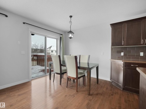 Dining space featuring dark wood finished floors and a textured ceiling - 1716 64 Street, Edmonton, AB - Indoor