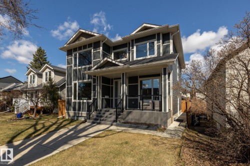 View of front of house with a sunroom and a front lawn - 10936 71 Avenue, Edmonton, AB - Outdoor