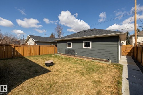 Rear view of house with a fenced backyard and roof with shingles - 10936 71 Avenue, Edmonton, AB - Outdoor