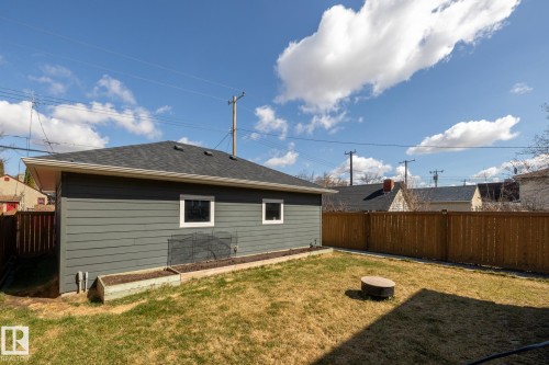 Back of house with a fenced backyard and roof with shingles - 10936 71 Avenue, Edmonton, AB - Outdoor