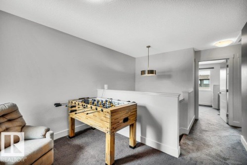 Rec room featuring carpet flooring and a textured ceiling - 6485 King Wynd, Edmonton, AB - Indoor