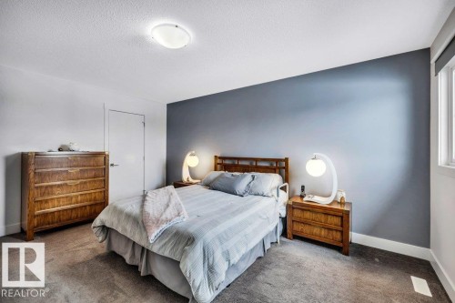 Bedroom featuring dark carpet and a textured ceiling - 6485 King Wynd, Edmonton, AB - Indoor Photo Showing Bedroom