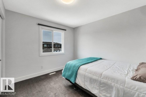 Bedroom with baseboards and dark colored carpet - 6485 King Wynd, Edmonton, AB - Indoor Photo Showing Bedroom