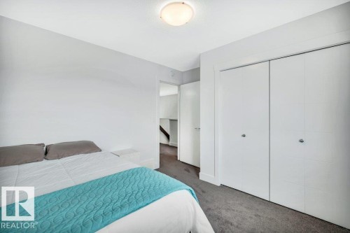 Bedroom featuring dark colored carpet and a closet - 6485 King Wynd, Edmonton, AB - Indoor Photo Showing Bedroom