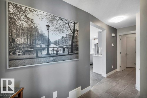 Corridor with a textured ceiling and light tile patterned floors - 6485 King Wynd, Edmonton, AB - Indoor Photo Showing Other Room