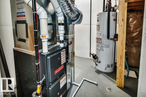 Utilities featuring heating unit and gas water heater - 6485 King Wynd, Edmonton, AB - Indoor Photo Showing Basement