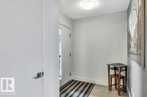 Foyer featuring a textured ceiling and baseboards - 6485 King Wynd, Edmonton, AB - Indoor Photo Showing Other Room