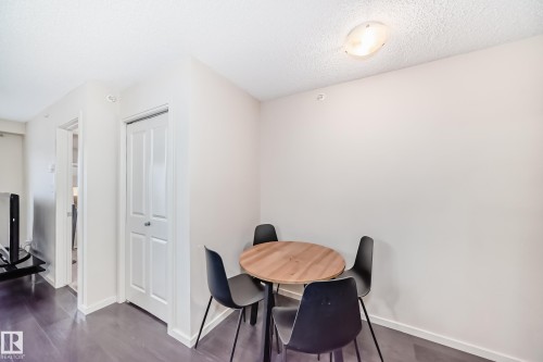 Dining room with a textured ceiling and dark wood-style floors - 403 340 Windermere Road, Edmonton, AB - Indoor