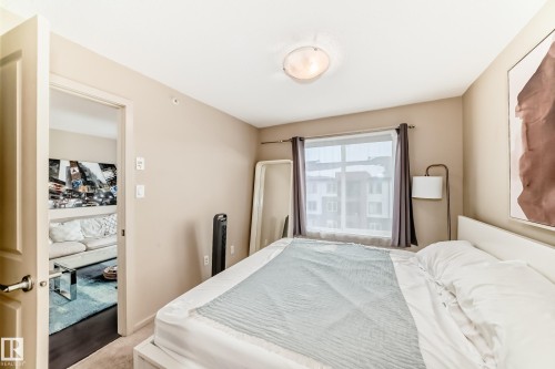 Bedroom featuring light colored carpet - 403 340 Windermere Road, Edmonton, AB - Indoor Photo Showing Bedroom