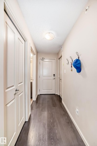 Corridor featuring dark wood-style flooring and a textured ceiling - 403 340 Windermere Road, Edmonton, AB - Indoor Photo Showing Other Room