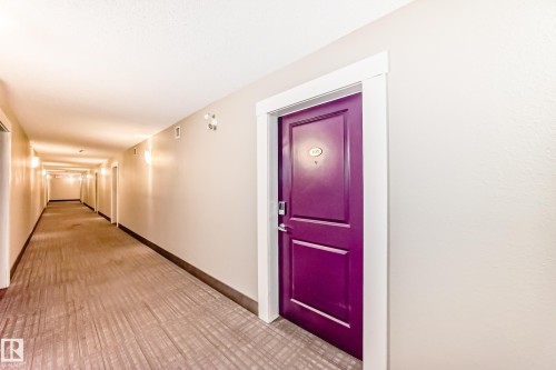 Hall featuring baseboards and light carpet - 403 340 Windermere Road, Edmonton, AB - Indoor Photo Showing Other Room