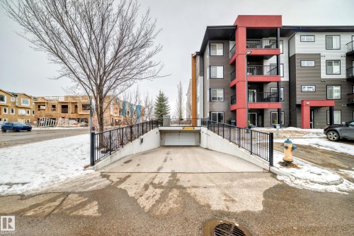 Snow covered building featuring a view of apartment building / complex - 403 340 Windermere Road, Edmonton, AB - Outdoor
