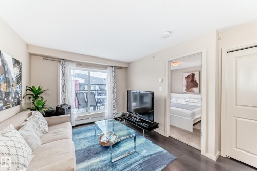 Living room with dark wood-style flooring - 403 340 Windermere Road, Edmonton, AB - Indoor Photo Showing Living Room