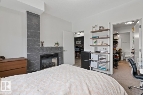 408 11203 103A Avenue, Edmonton, AB - Indoor Photo Showing Bedroom With Fireplace