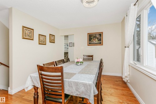 Dining area featuring light wood-style flooring and a textured ceiling - 18507 92 Avenue, Edmonton, AB - Indoor Photo Showing Dining Room