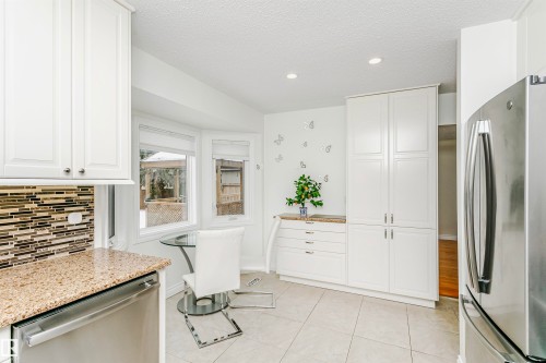 Kitchen with stainless steel appliances, white cabinetry, a textured ceiling, recessed lighting, and light stone countertops - 18507 92 Avenue, Edmonton, AB - Indoor Photo Showing Kitchen