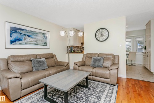 Living area featuring light wood-type flooring and a textured ceiling - 18507 92 Avenue, Edmonton, AB - Indoor Photo Showing Living Room
