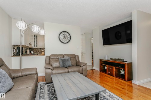 Living room with light wood-style floors and a textured ceiling - 18507 92 Avenue, Edmonton, AB - Indoor Photo Showing Living Room