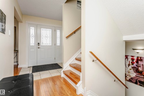 Foyer entrance with a textured ceiling and light wood finished floors - 18507 92 Avenue, Edmonton, AB - Indoor Photo Showing Other Room