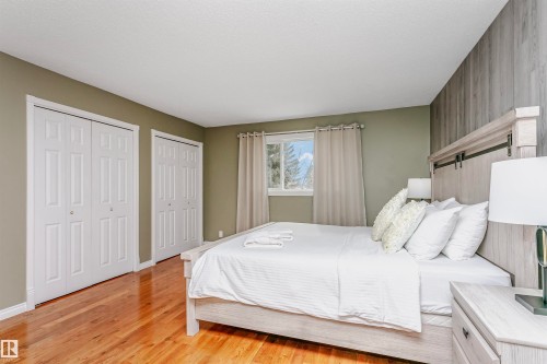 Bedroom with two closets and light wood-type flooring - 18507 92 Avenue, Edmonton, AB - Indoor Photo Showing Bedroom