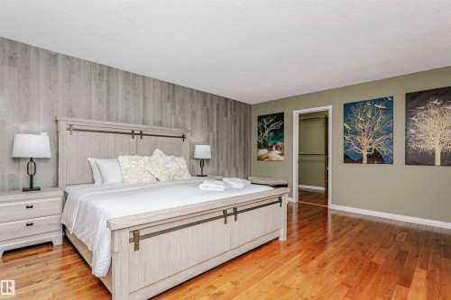 Bedroom with light wood-type flooring and an accent wall - 18507 92 Avenue, Edmonton, AB - Indoor Photo Showing Bedroom