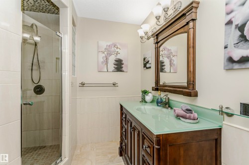 Bathroom featuring vanity, a shower stall, tile walls, and wainscoting - 18507 92 Avenue, Edmonton, AB - Indoor Photo Showing Bathroom