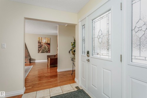 Foyer entrance featuring a textured ceiling and light tile patterned flooring - 18507 92 Avenue, Edmonton, AB - Indoor Photo Showing Other Room